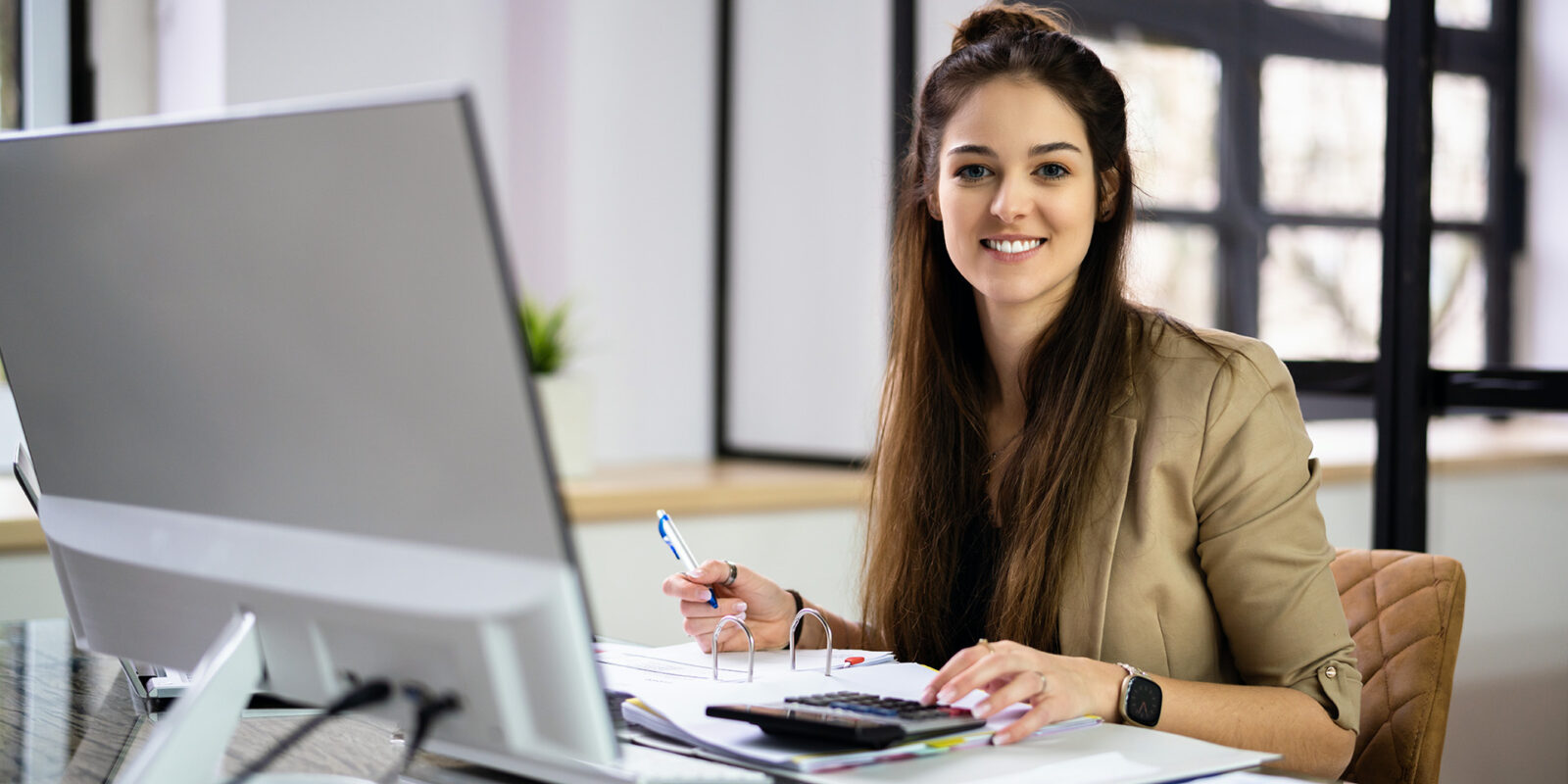 MBA-Accountant-1 MBA in Accounting student at desk using calculator