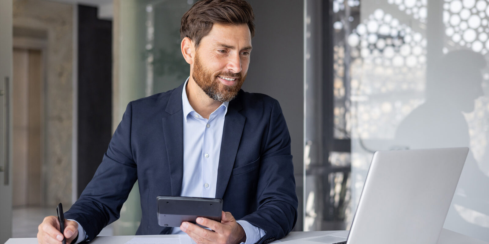 Business man reviewing chart on laptop
